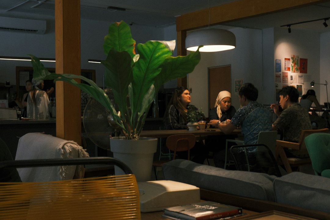 A group of people talking around a cafe table