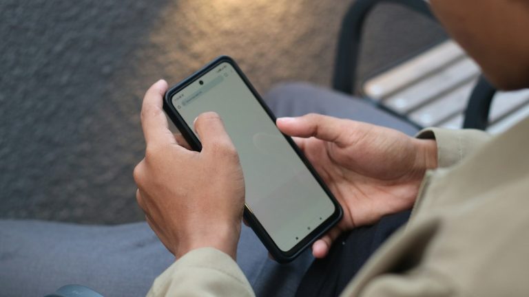 Close-up of hands navigating a smartphone screen
