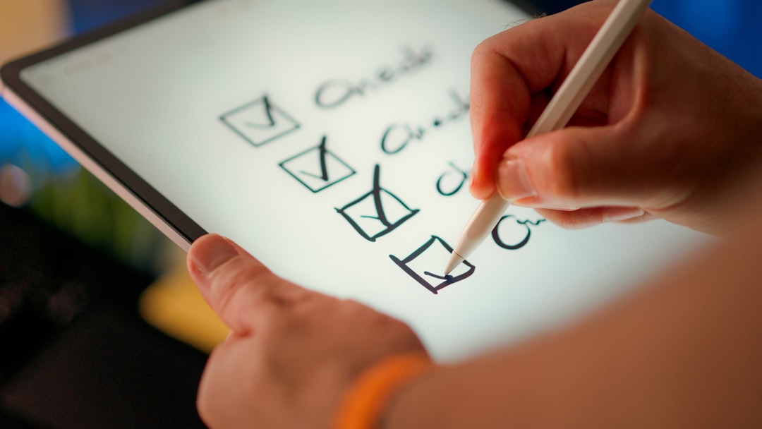 A hand ticking checkboxes on a digital checklist