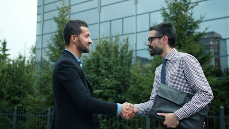 Two people shaking hands at the start of a working relationship